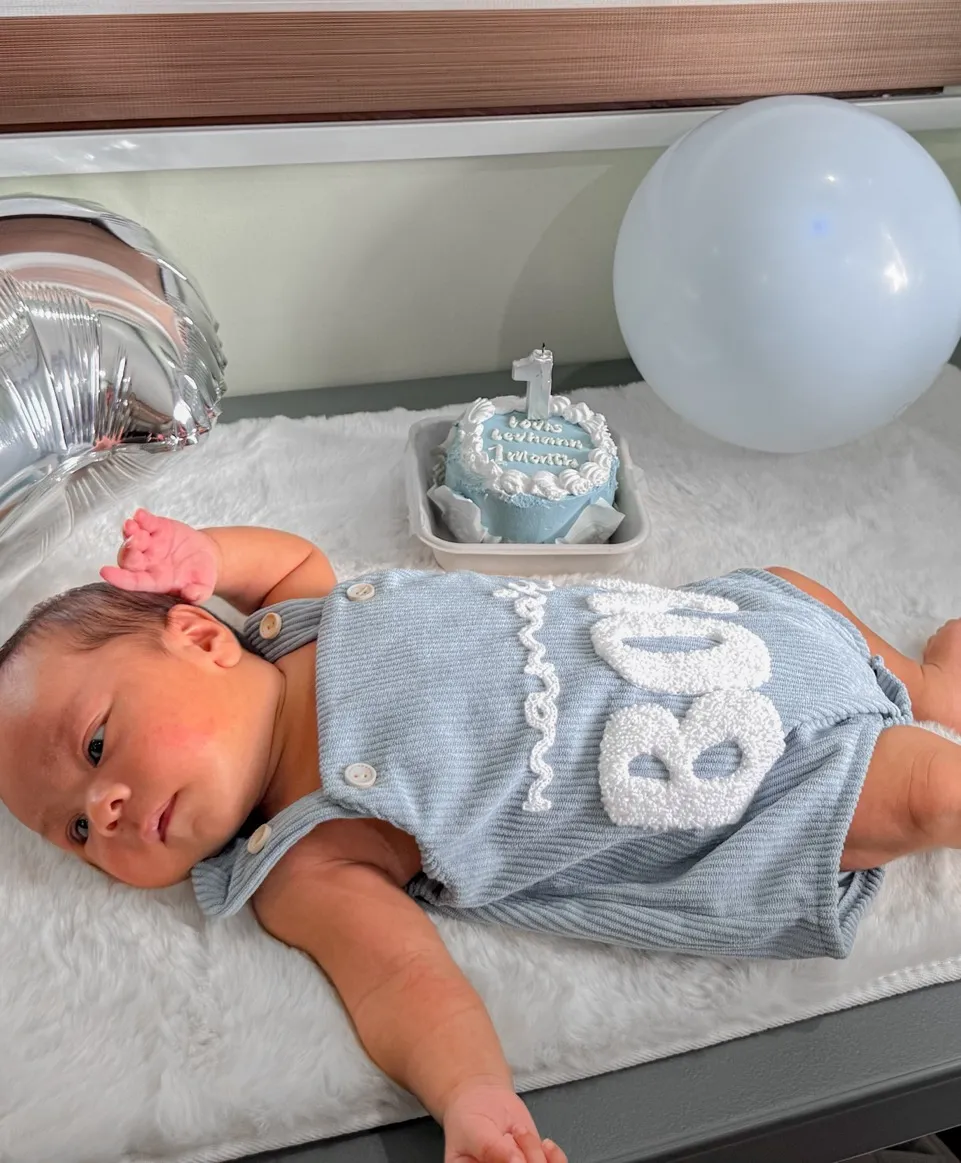 Baby Louis with his little blue cake and balloons